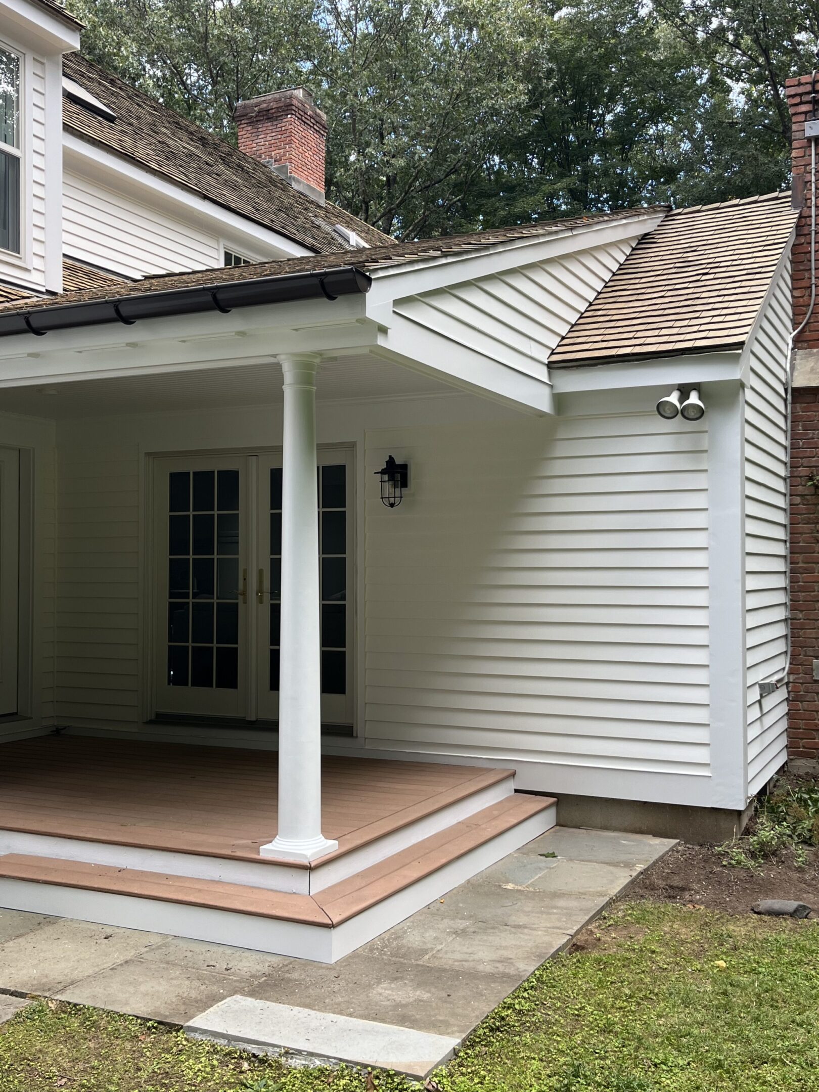 A porch with a roof and a door.