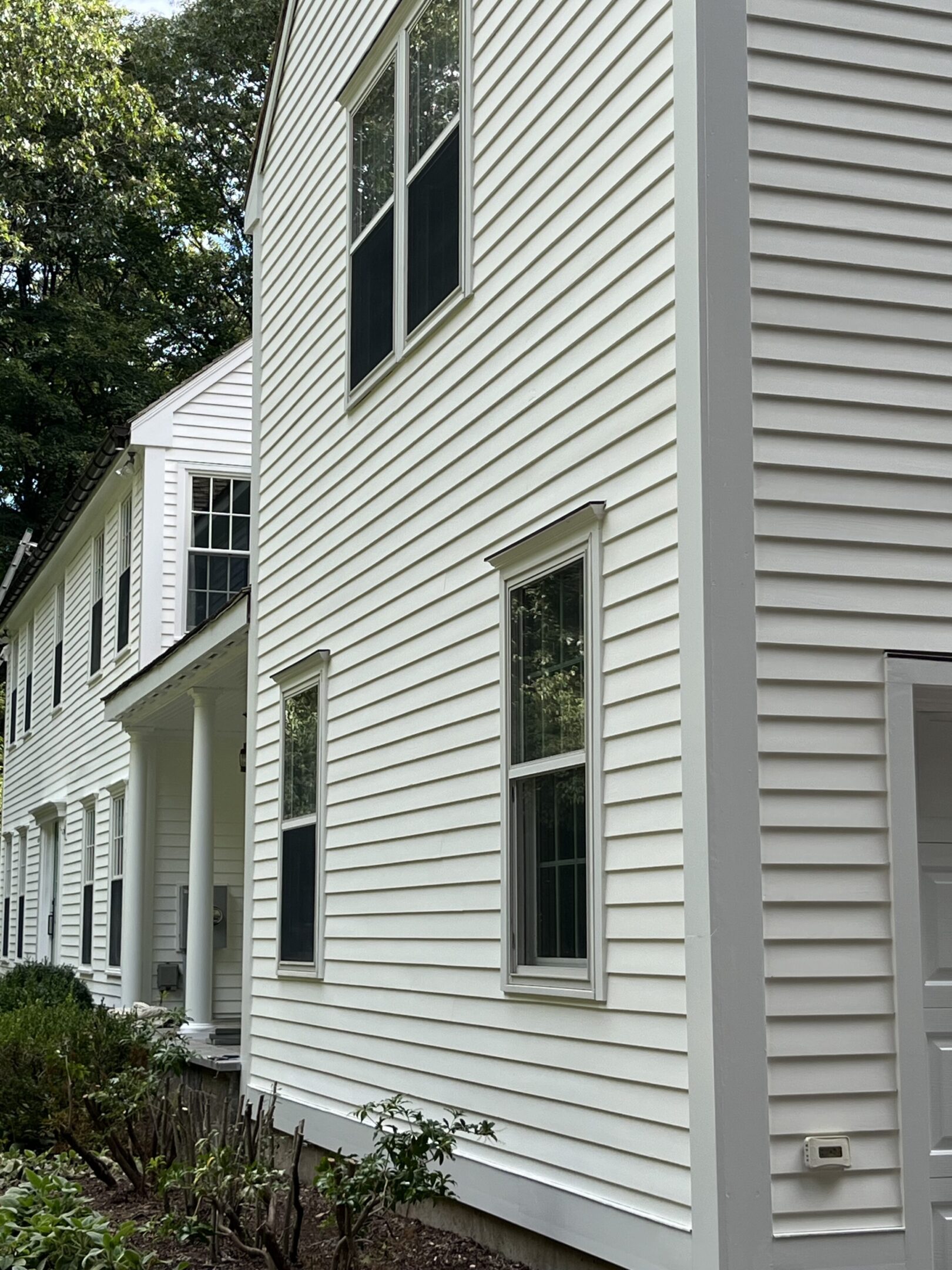 A white house with two windows and a door.