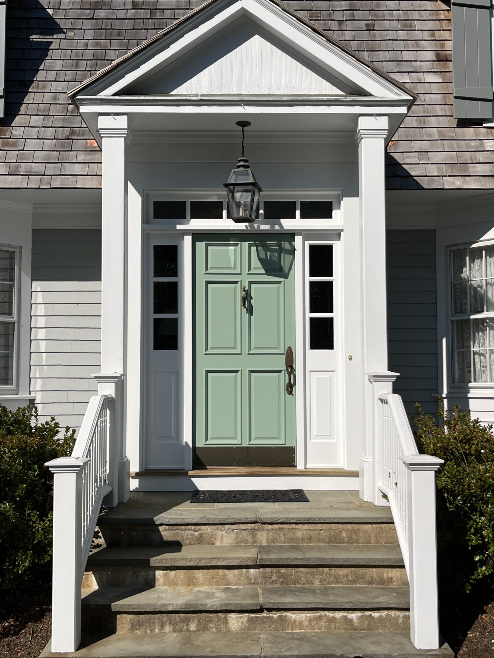 A front door of a house with steps leading to it.