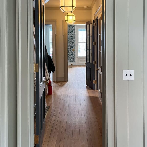 Interior hallway with doors and pendant lights.
