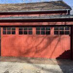Red garage door with windows and a lighting.
