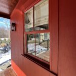 Red house exterior with window and a snow.