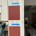 Paint color samples on an wooden wall.
