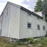 Side view of an light gray house.