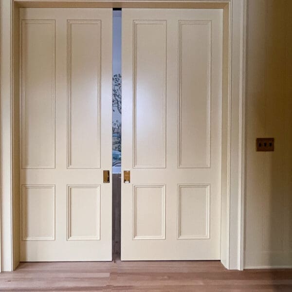 Double doors in a light-colored room.