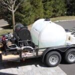 Water tank trailer parked on driveway.