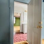 Open door to a colorful room interior.