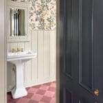 Powder room with floral wallpaper and checkered tiles