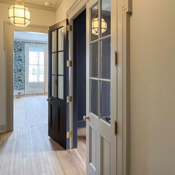Sunlit hallway with open glass-paneled doors