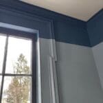 Window with blue two-tone walls and molding