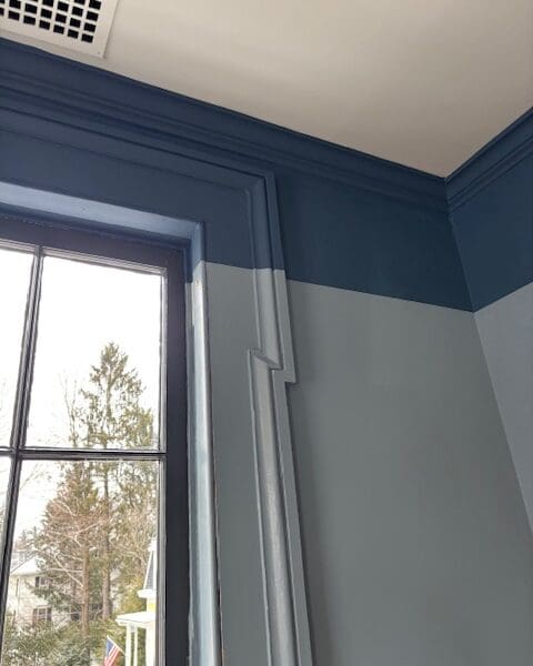 Window with blue two-tone walls and molding