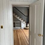 Open doorway to room with hardwood staircase