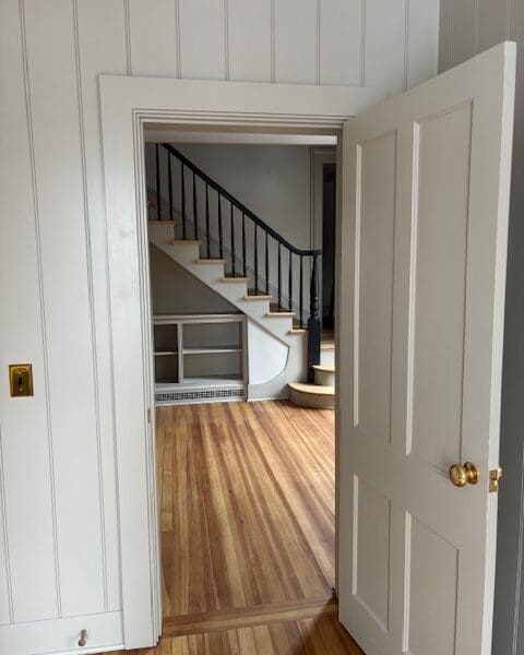 Open doorway to room with hardwood staircase