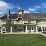 Large two-story house with porch and lawn